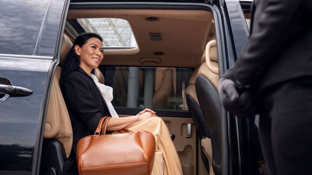 Driver opens the car door for the passenger.
