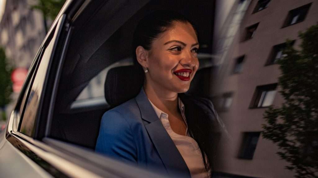 woman enjoying the luxury car service