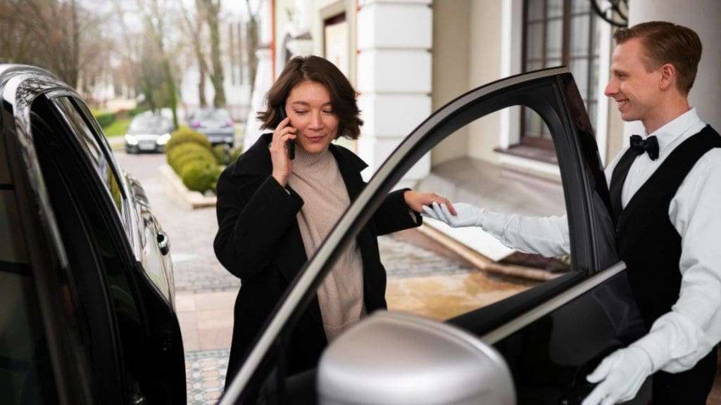 Corporate chauffeur assisting customer on the Gold Coast
