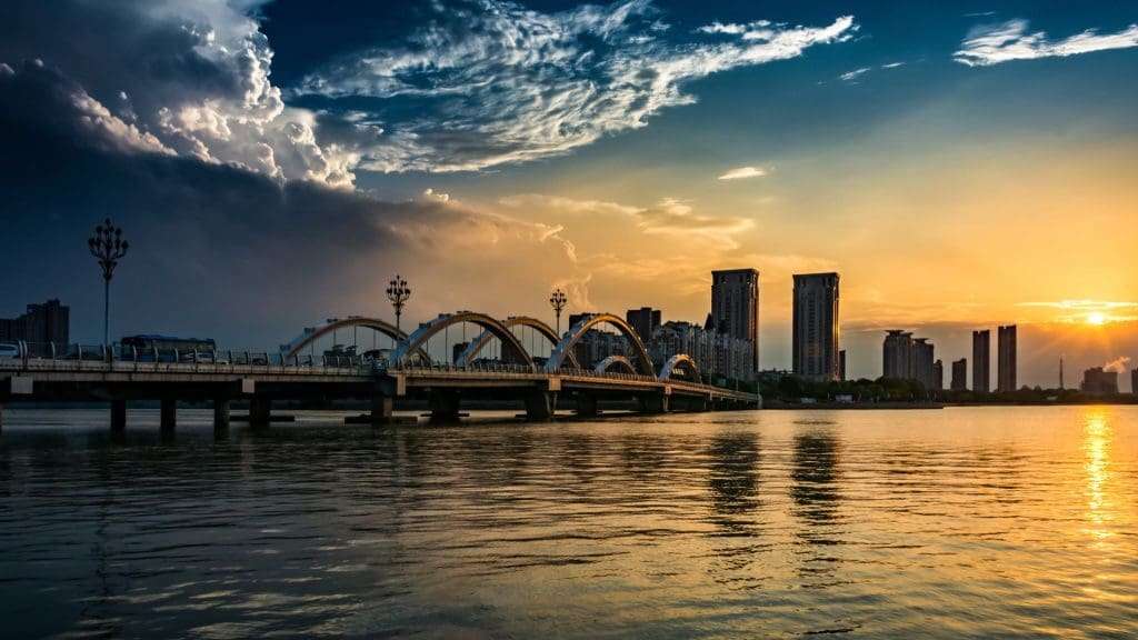 Brisbane River flowing through vibrant cityscape under clear blue sky