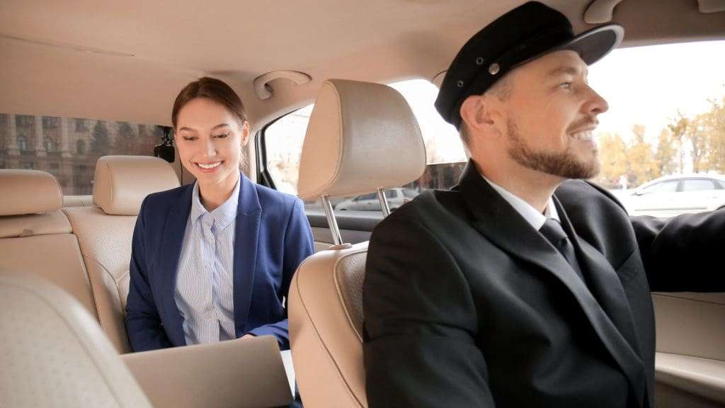 Chauffeur car in Melbourne with happy client in backseat smiling