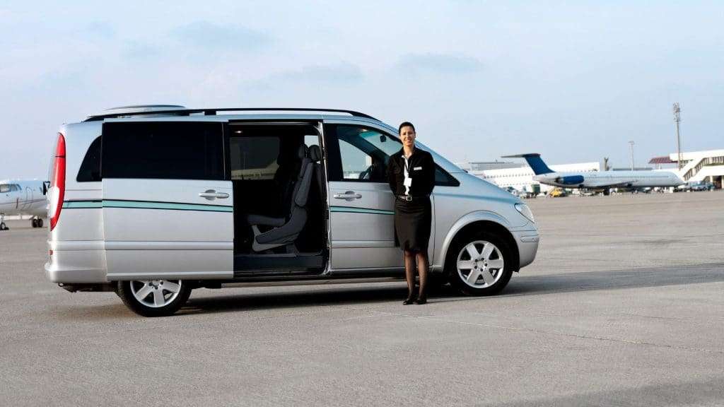 Woman in front of corporate chauffeur car, Gold Coast Australia.