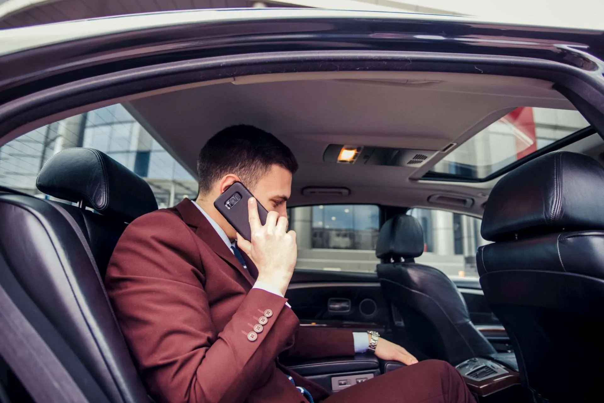 Businessman having a meeting in a limo car