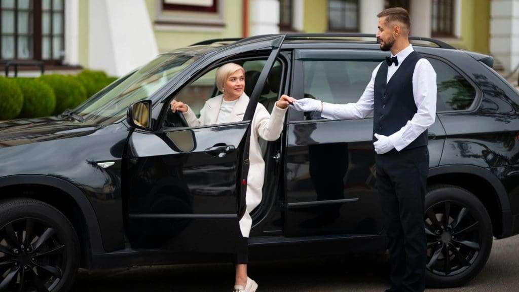 Executive Chauffeur Services Gold Coast Woman exiting car with chauffeur's assistance in Gold Coast.