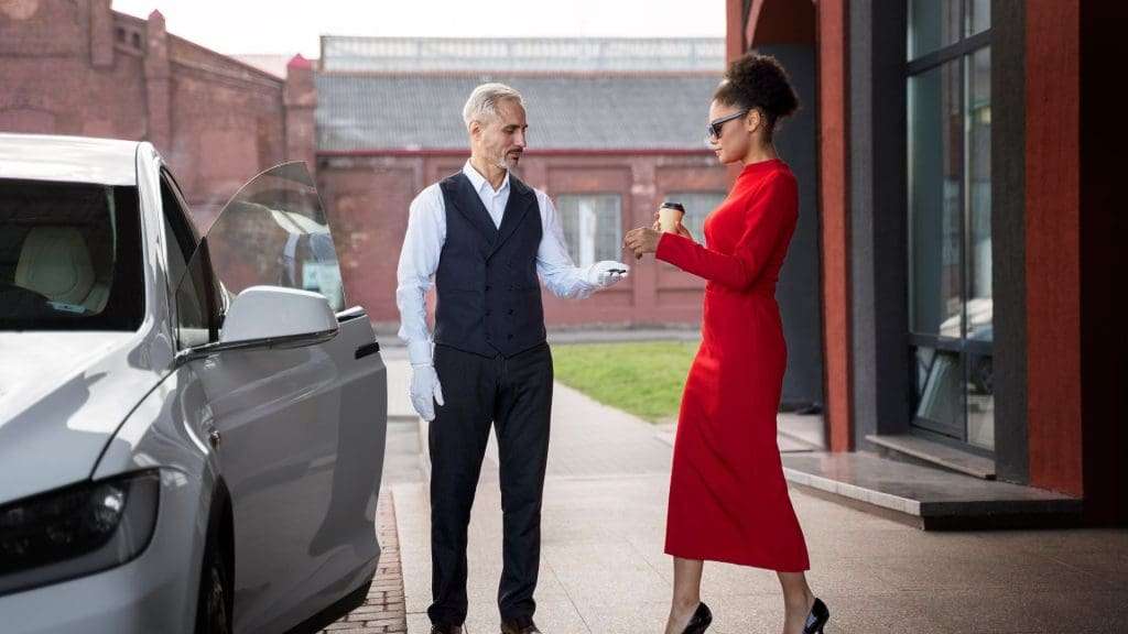 The Imperial Experience chauffeur opens car door