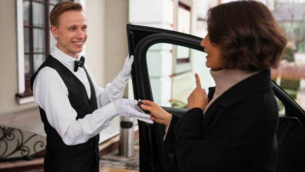 Gold Coast chauffeur assists elegant woman into luxury car with professional courtesy
