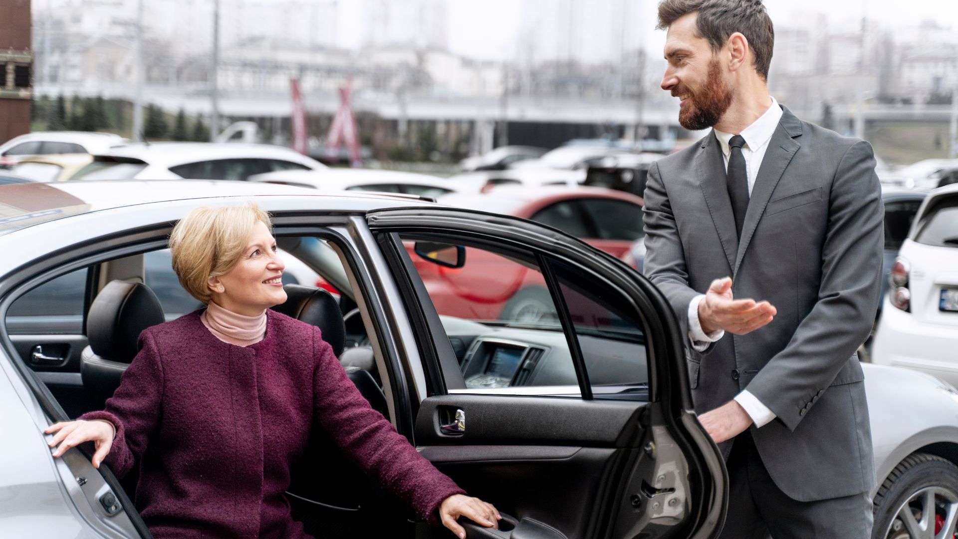 Business Class Transfers chauffeur assisting passenger