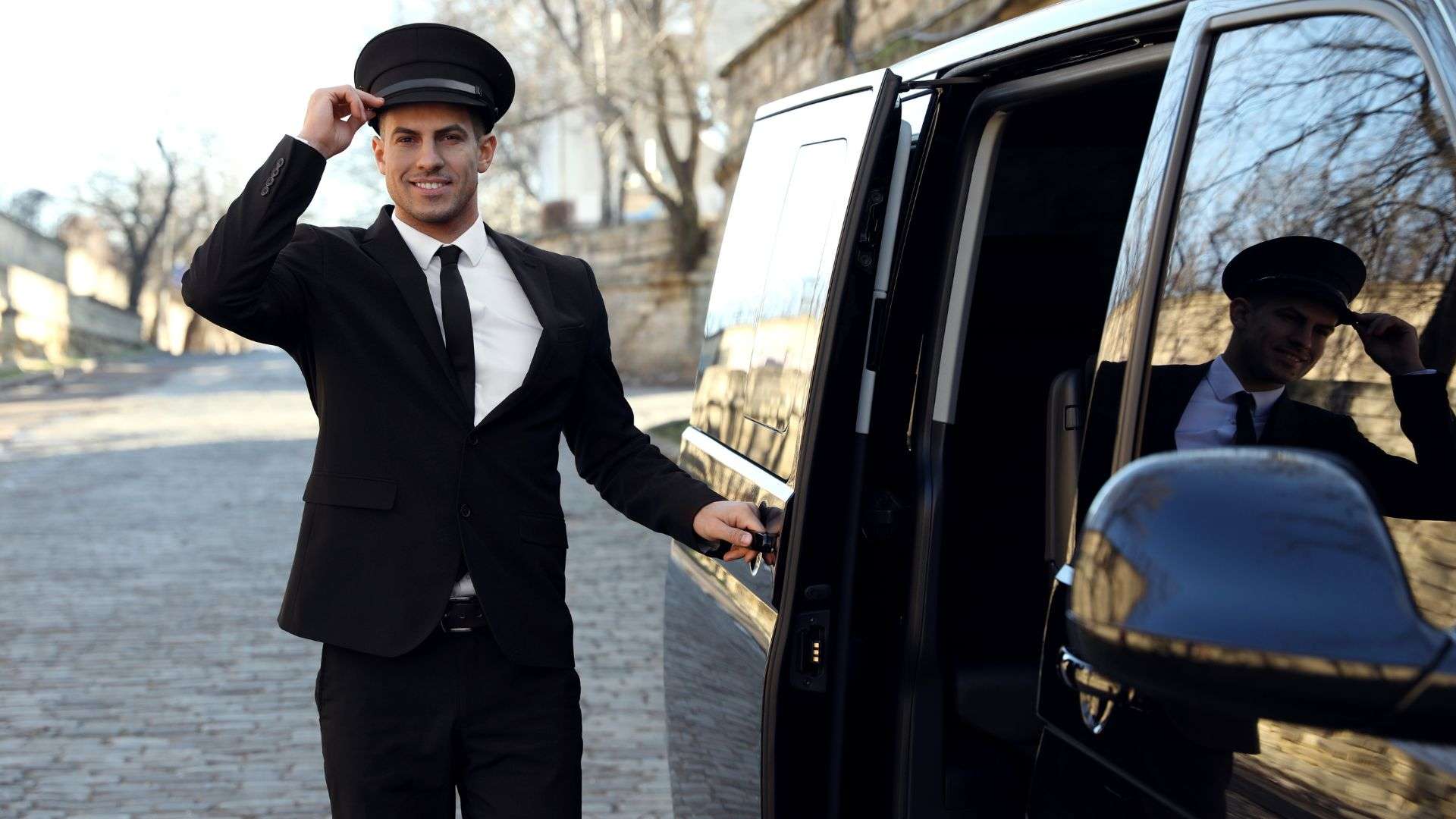 Luxury Chauffeur Service driver tipping his hat.