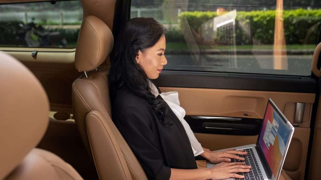 Executive Transfers businesswoman working on a laptop.
